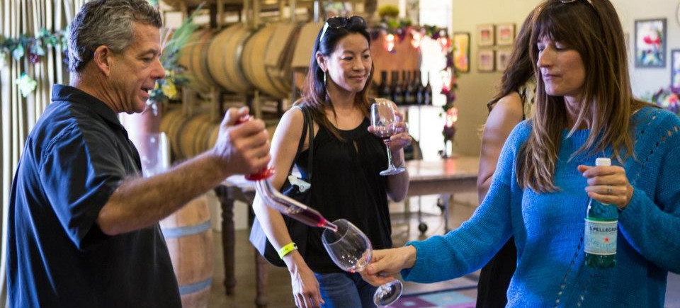 Michael Talty serving wine at Barrel Tasting Weekend